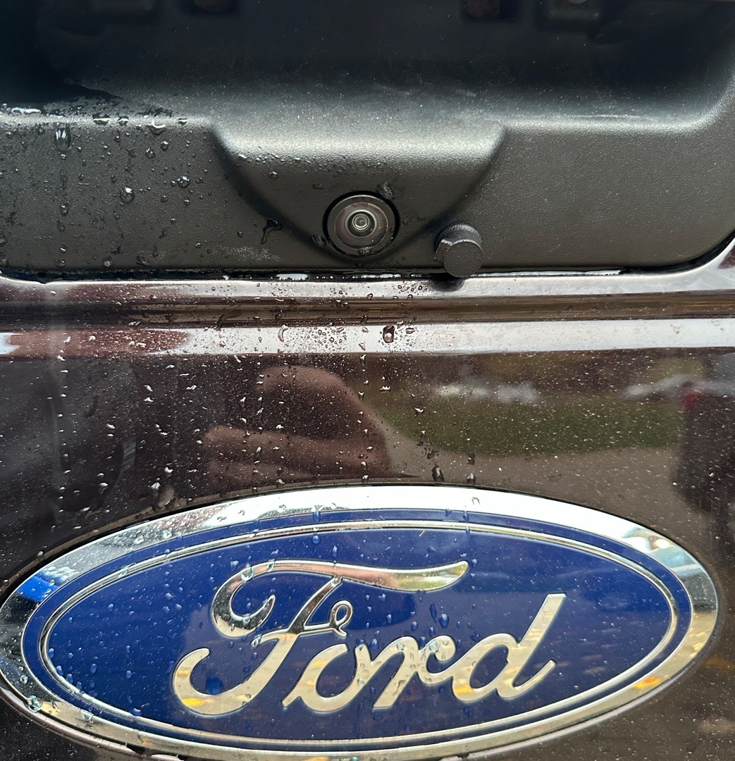 Wet Ford tailgate camera after a rain wash